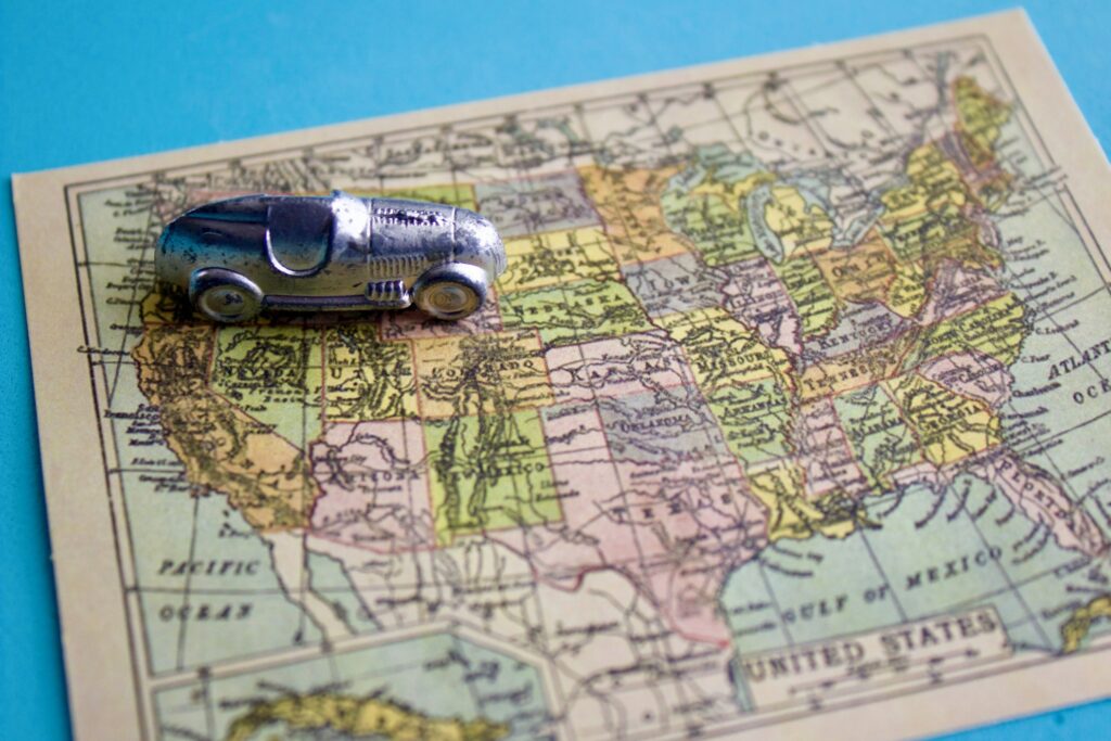 miniature-silver-racer-heading-east-on-a-miniature-vintage-map-of-the-united-states-of-america_t20_-Envato